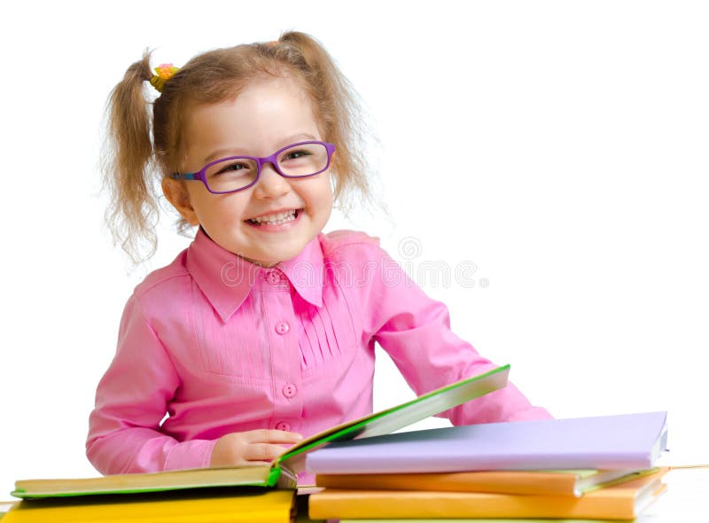 Happy child girl in glasses reading books sitting