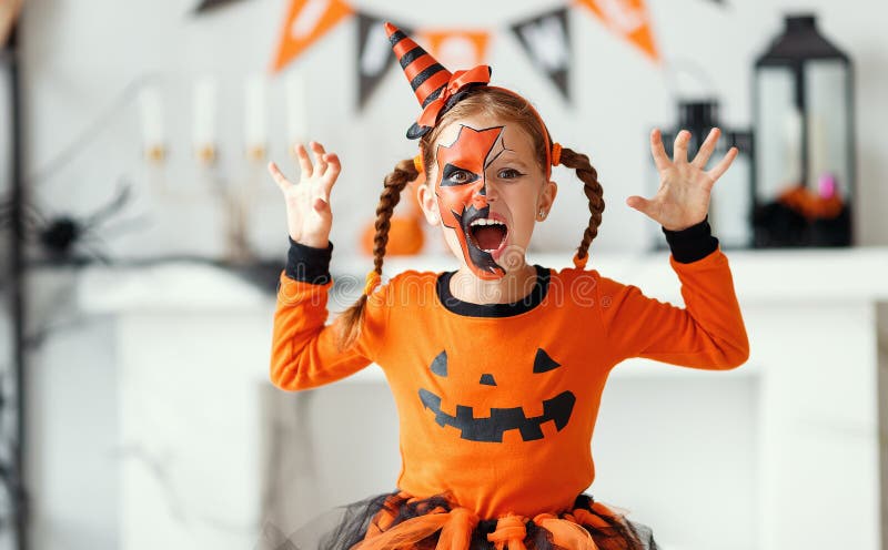 Happy child girl in pumpkin costume to halloween stock images Happy child girl in pumpkin costume to halloween stock images