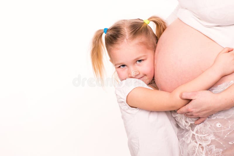 Happy child holding belly of pregnant woman