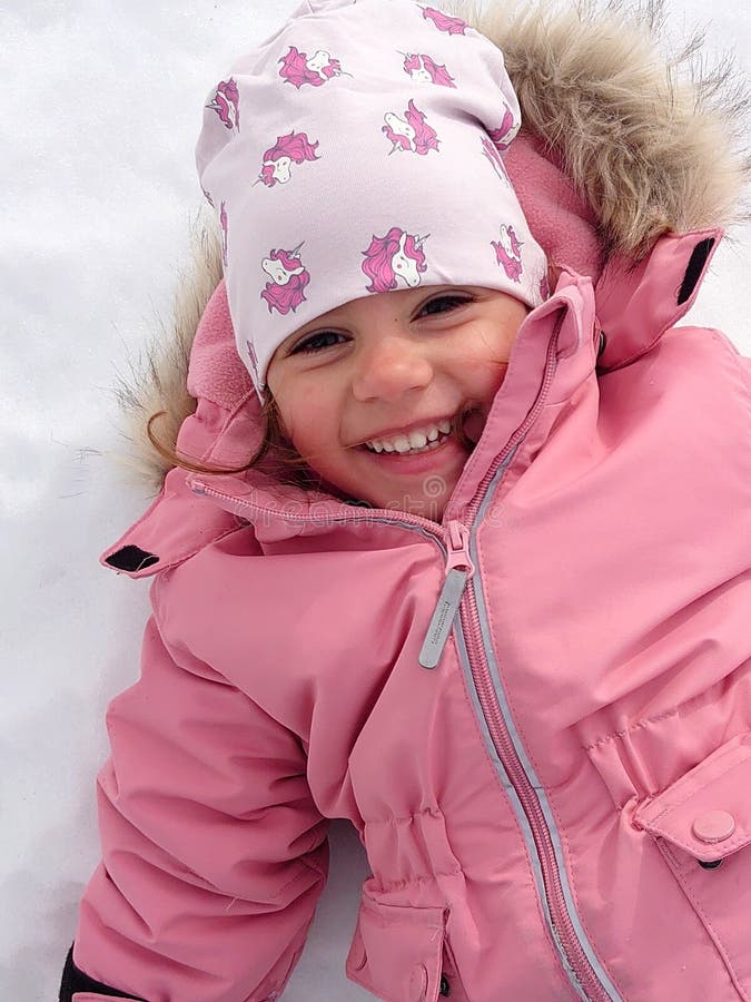 Happy Child Making a Snow Angel Stock Photo Image of pink, face