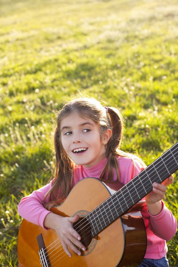 happy child playing guitar