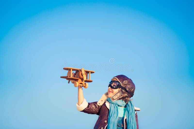 Happy child playing with toy airplane