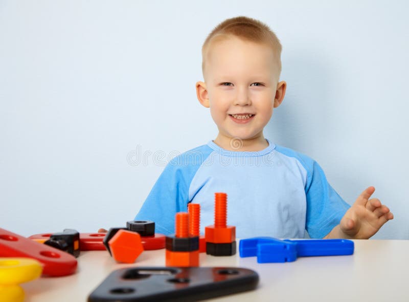 Little Boy Playing with Color Toys on Floor Stock Photo - Image of  bulldozer, little: 19039326