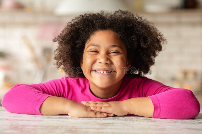 Happy Child. Portrait Of Cheerful Cute Little Black Girl Sitting At Table