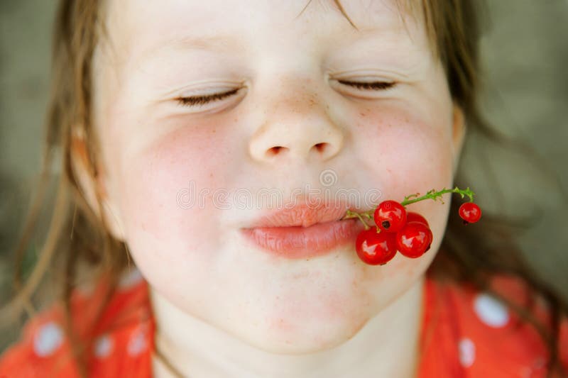 Happy child with red currants