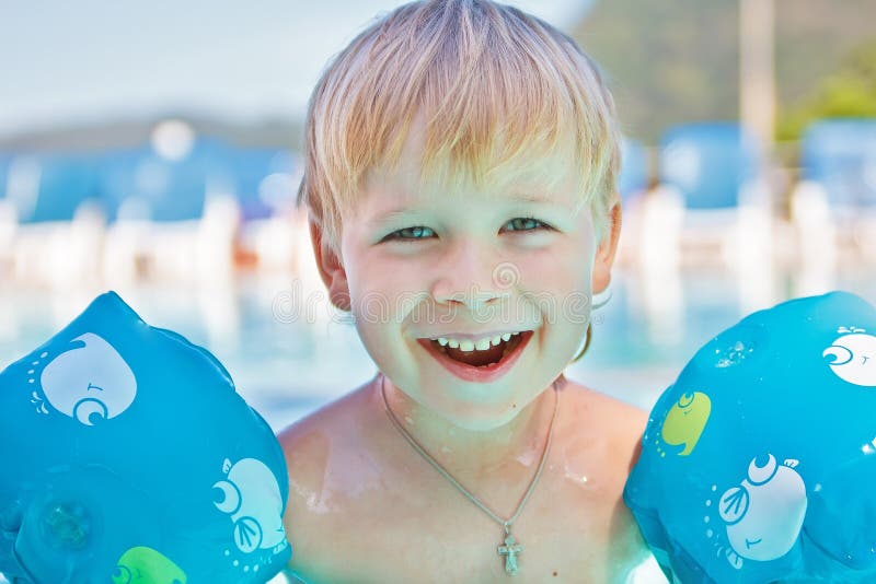 Happy child in the swimming-pool