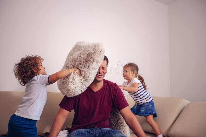 Happy childhood - children boy and girl playing with father together at home. stock images Happy childhood - children boy and girl playing with father together at home. stock images