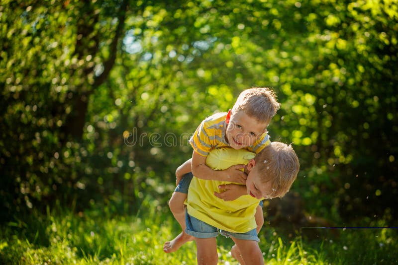 Happy children, boy friends, playing on the summer park, kids ha stock photos Happy children, boy friends, playing on the summer park, kids ha stock photos