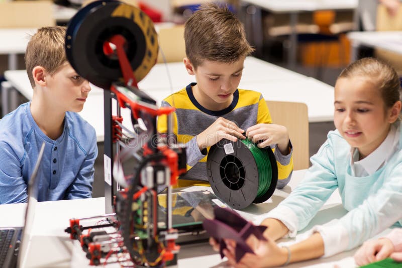 Happy children with 3d printer at robotics school royalty free stock image