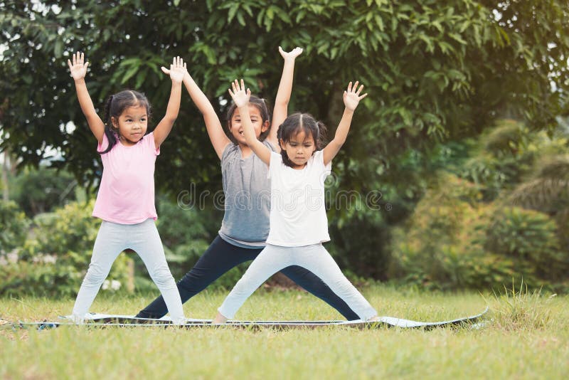 Happy children doing exercise together in outdoor royalty free stock images Happy children doing exercise together in outdoor royalty free stock images
