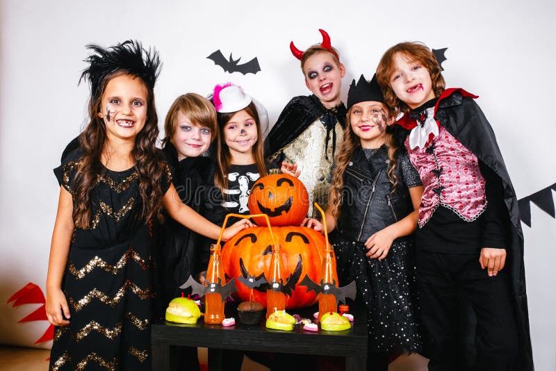 Happy brothers and two sisters on Halloween party stock images Happy brothers and two sisters on Halloween party stock images