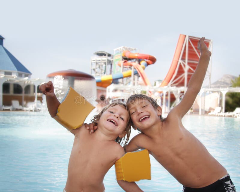 Two happy children having fun in aqua water park