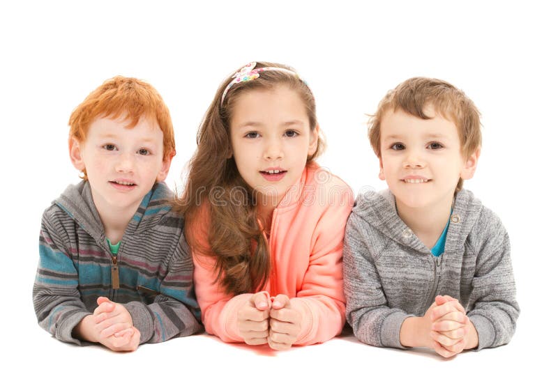 Happy children laying on floor royalty free stock images Happy children laying on floor royalty free stock images