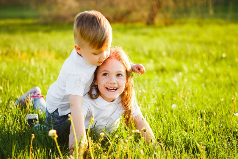 Happy Children Lying on Green Grass in Spring Park. Stock Image - Image ...