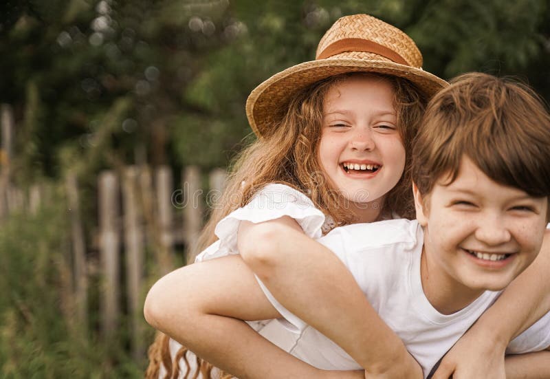 Happy children with piggyback riding in sunset light stock images Happy children with piggyback riding in sunset light stock images