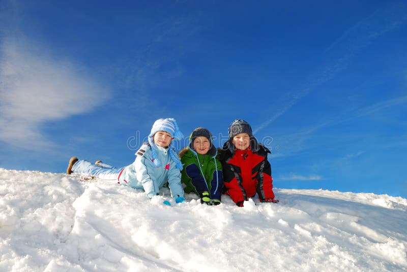 Tres en la nieve sobre el claro, soleado.