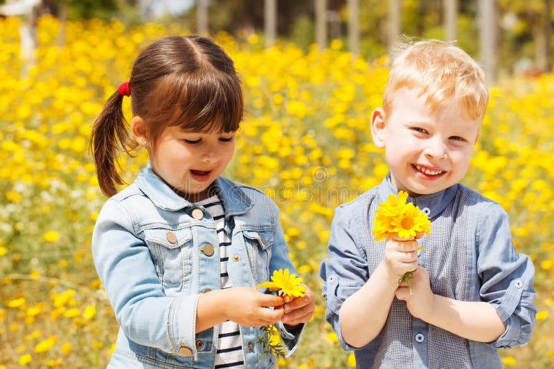 Happy children with yellow flowers.