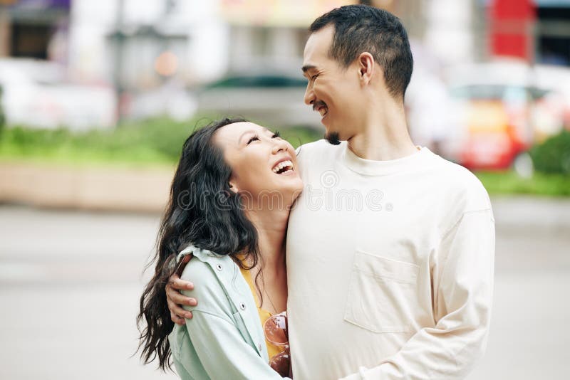 Chinese Boyfriend And Girlfriend Playing Video Games Sitting At