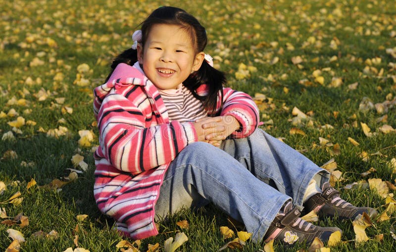 Happy chinese girl on the meadow