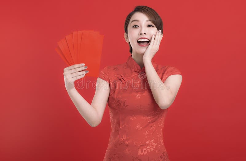 Happy chinese new year. suprised young Woman holding Red envelopes for lucky