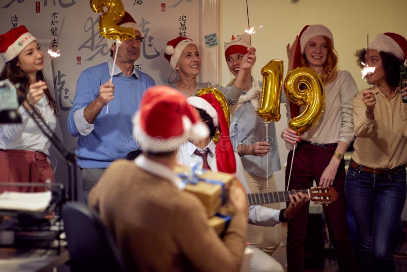 Happy colleagues in Santa caps having Christmas fun royalty free stock image Happy colleagues in Santa caps having Christmas fun royalty free stock image