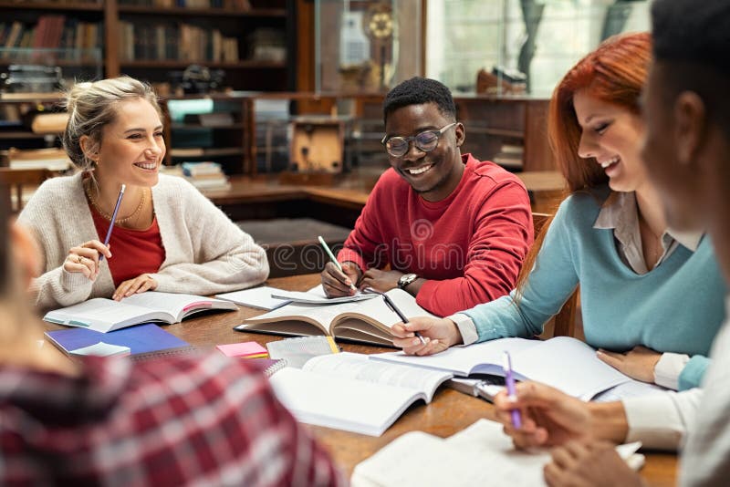 Happy college students studying together