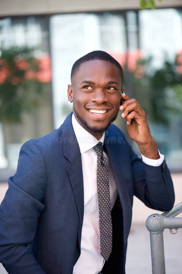 Happy confident businessman calling by cell phone