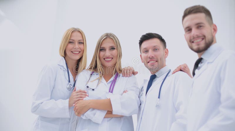 Happy and confident team of doctors posing on camera stock image Happy and confident team of doctors posing on camera stock image
