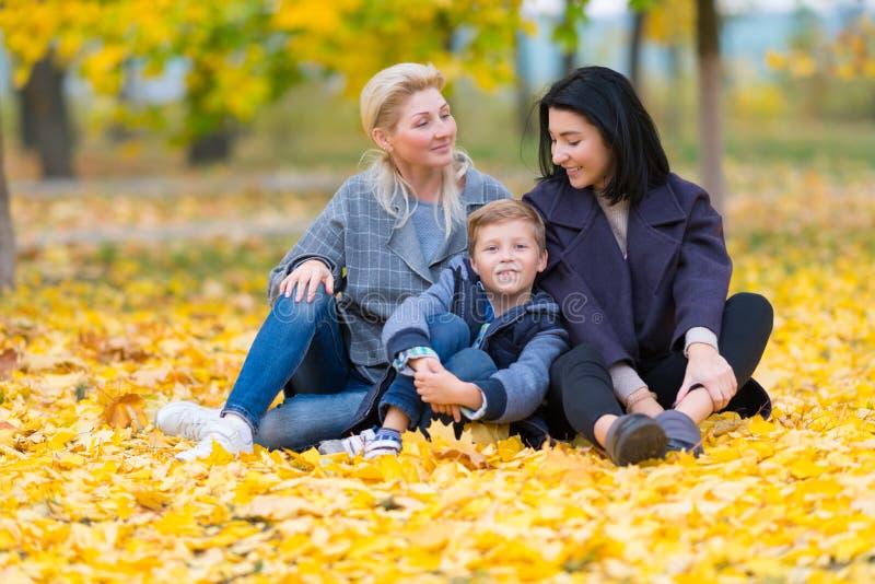 Content same sex female couple and son in park.