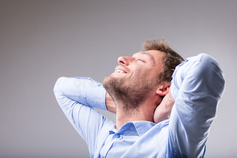 Happy contented man relaxing with a smile stock images
