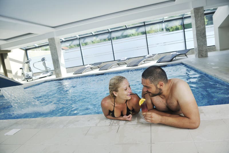 Happy cople relaxing at swimming pool