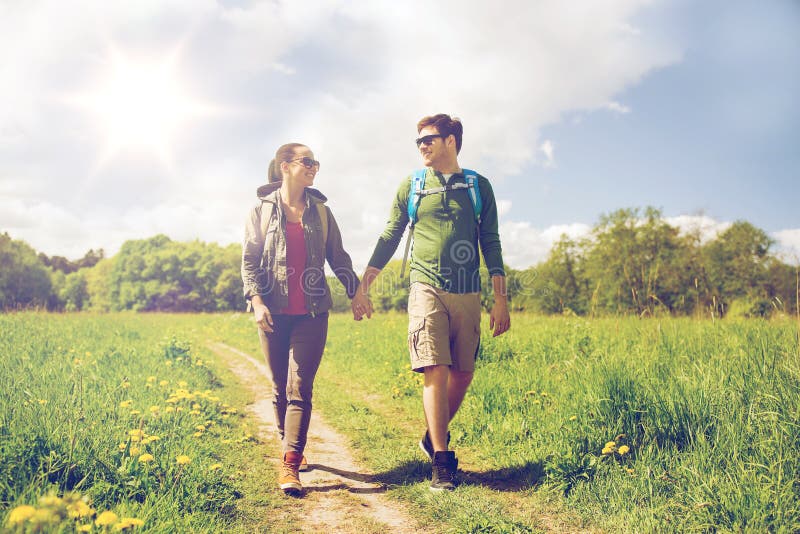 Happy couple with backpacks hiking outdoors stock image Happy couple with backpacks hiking outdoors stock image
