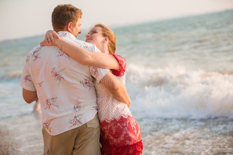 Happy couple on the beach stock images