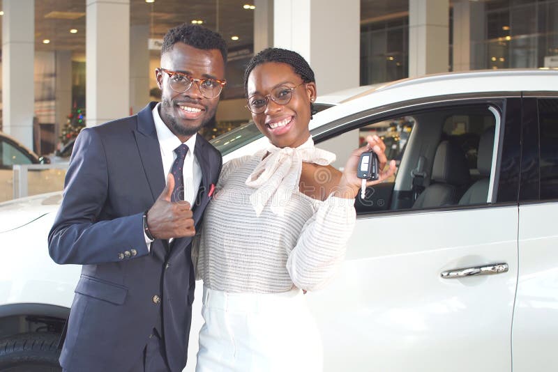 Happy couple buying new car in showroom. royalty free stock photography Happy couple buying new car in showroom. royalty free stock photography