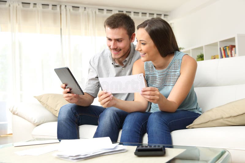 Happy couple checking bank account online stock photo Happy couple checking bank account online stock photo