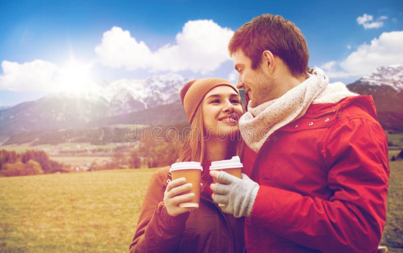 Happy couple with coffee cups over alps mountains royalty free stock photo Happy couple with coffee cups over alps mountains royalty free stock photo