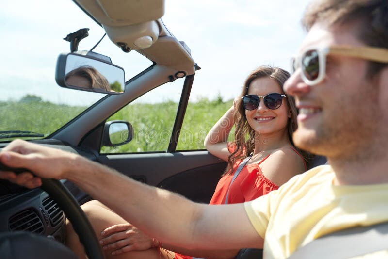 Happy couple driving in cabriolet car at country stock photo Happy couple driving in cabriolet car at country stock photo