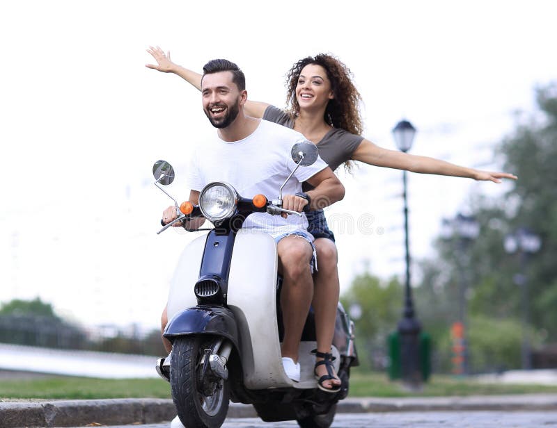 Happy couple driving scooter excited on summer holidays vacation