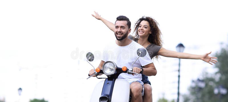 Happy couple driving scooter excited on summer holidays vacation