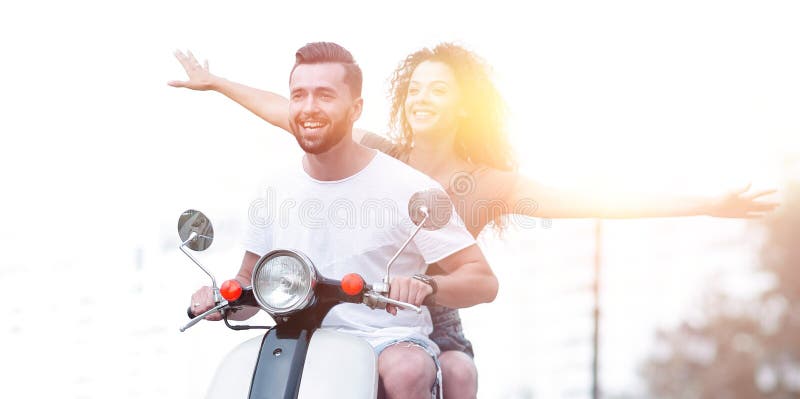 Happy couple driving scooter excited on summer holidays vacation