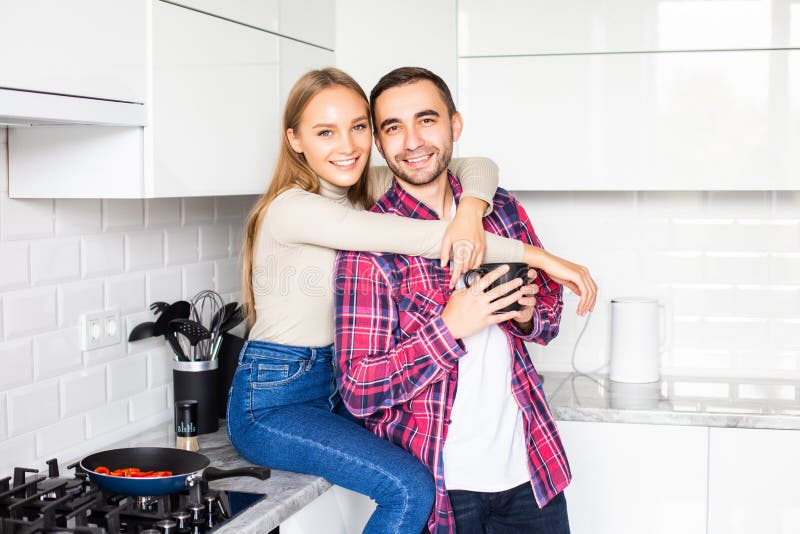 Happy young couple having breakfast together at home stock images