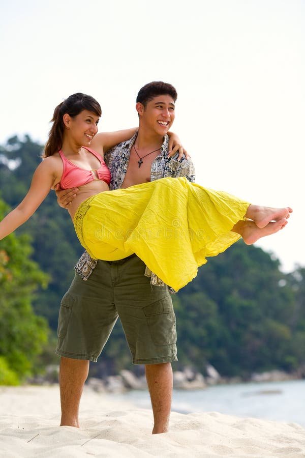 Happy couple having fun at the beach