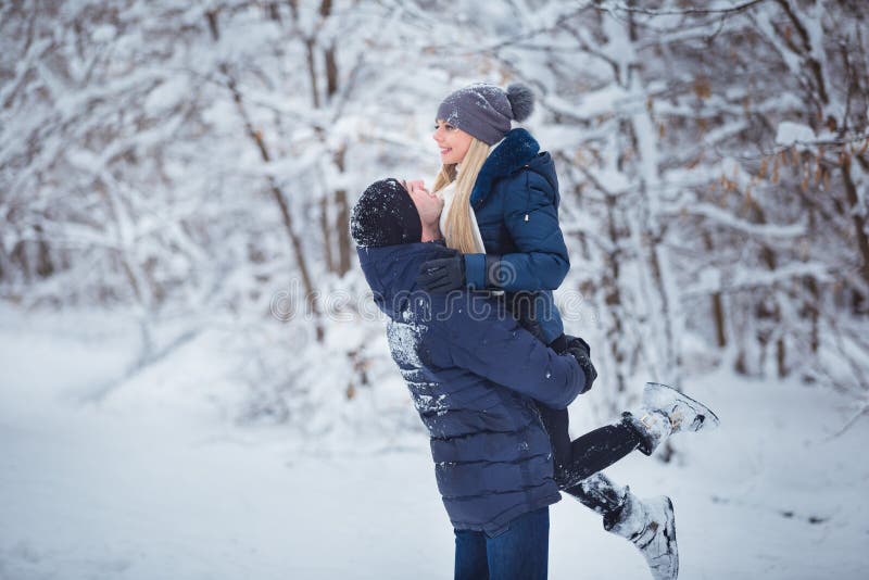 Happy Couple Having Fun Outdoors in Snow Park. Winter Vacation Stock