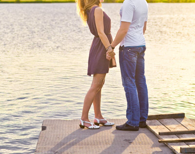 Happy couple hugging while standing on the bank of royalty free stock image Happy couple hugging while standing on the bank of royalty free stock image