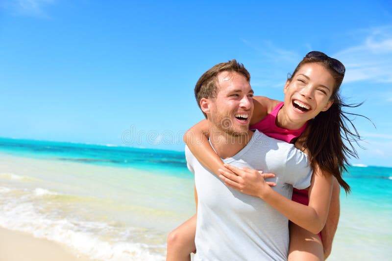 Happy couple in love on beach summer vacations