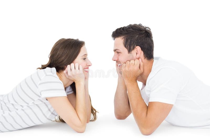 Happy couple lying on the floor looking to each other royalty free stock photo Happy couple lying on the floor looking to each other royalty free stock photo