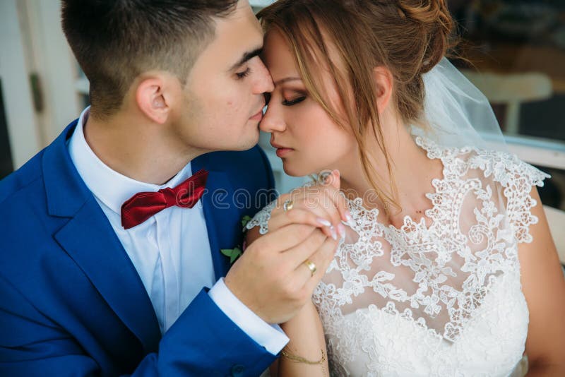 A happy couple of newlyweds gently embrace each other. A man with trembling holds the hand of his bride. The girl closed stock photography A happy couple of newlyweds gently embrace each other. A man with trembling holds the hand of his bride. The girl closed stock photography