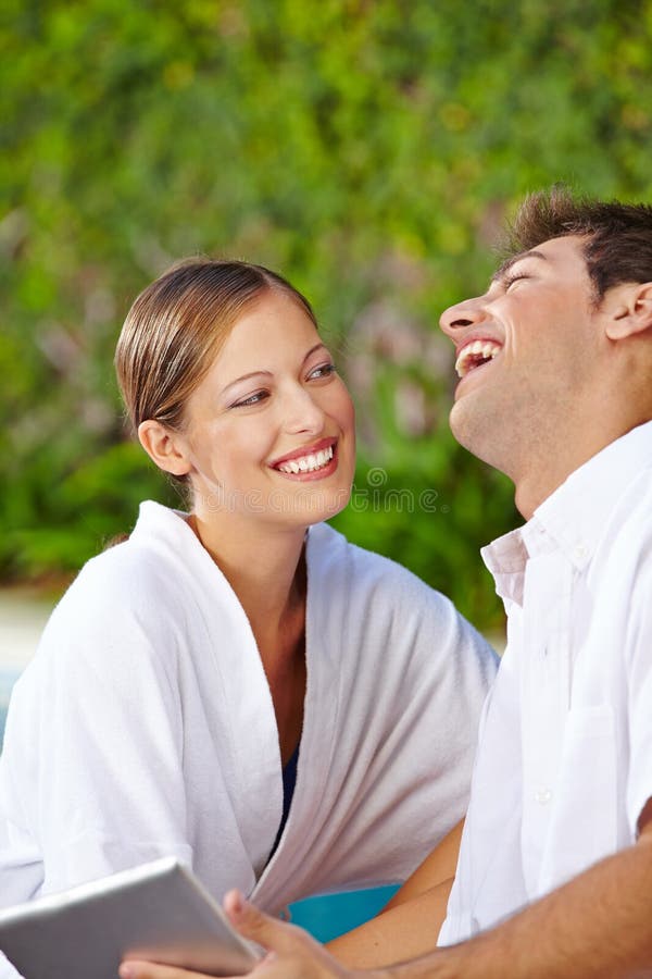 Happy couple at pool with tablet computer stock photos Happy couple at pool with tablet computer stock photos
