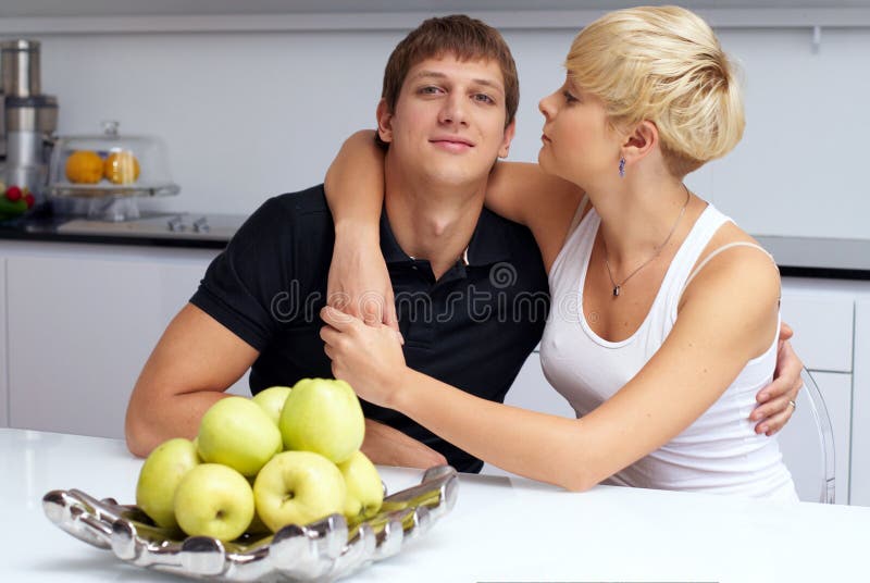 Happy couple posing in the kitchen