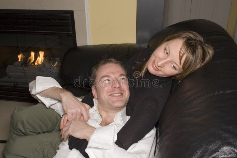 Happy couple relaxing on couch